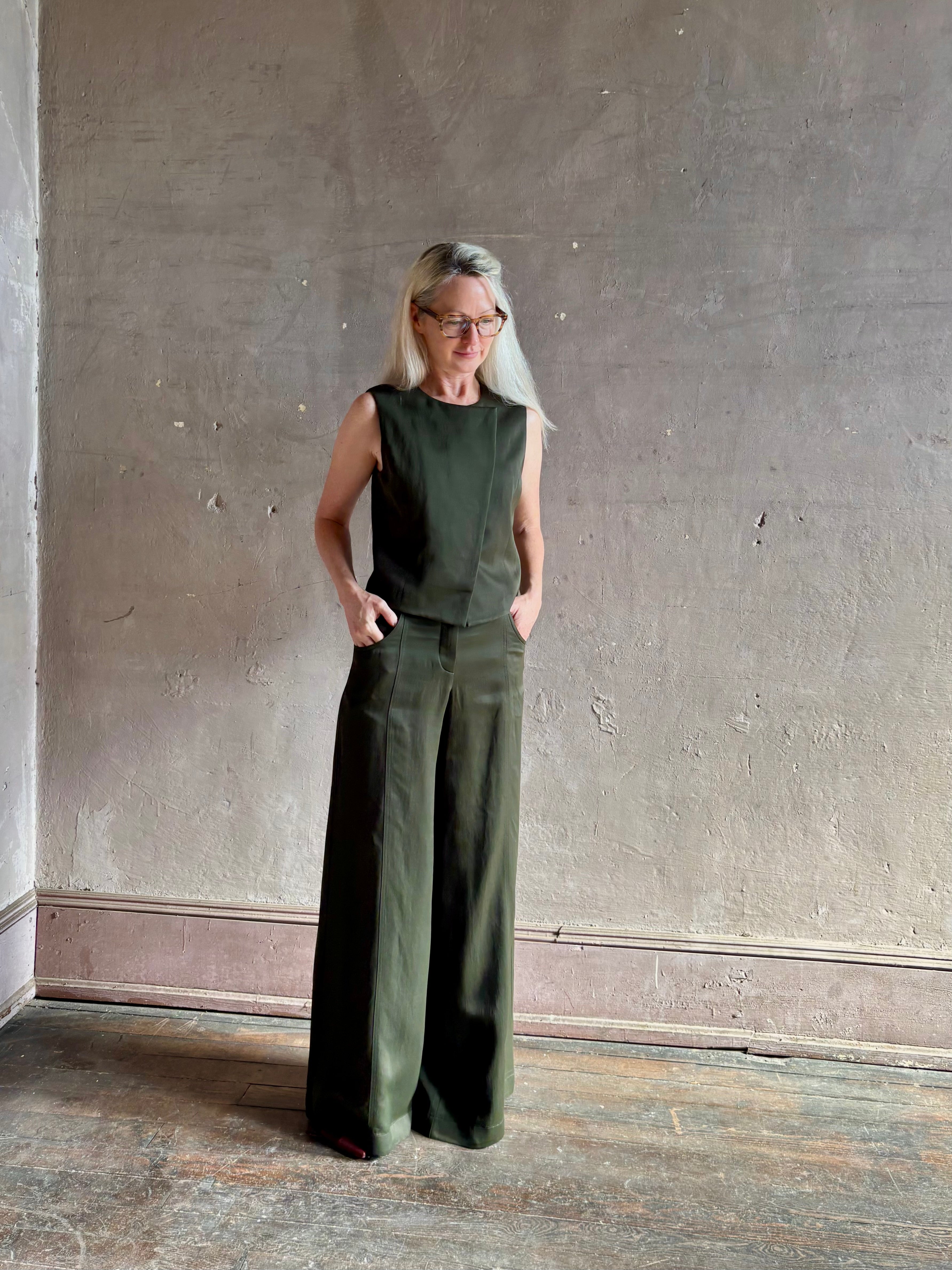 Luxury women's clothing brand TWP high neck hidden placket vest top with matching pant set in a green linen blend