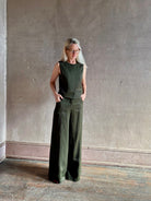 Luxury women's clothing brand TWP high neck hidden placket vest top with matching pant set in a green linen blend