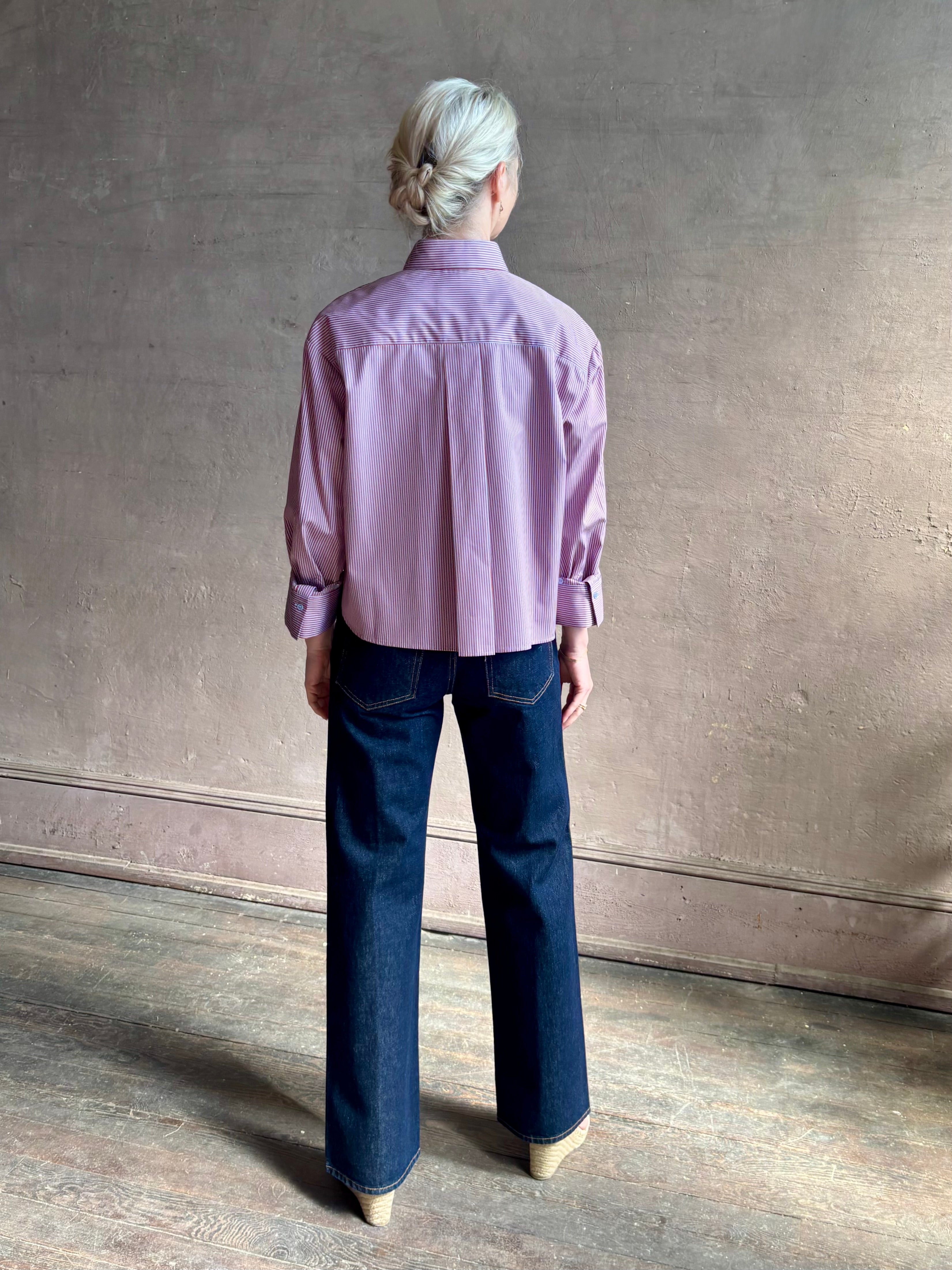 Woman wearing premium cotton poplin JD menswear inspired shirt from TWP  rust and blue stripe with long sleeve 