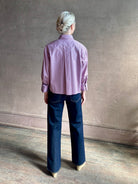 Woman wearing premium cotton poplin JD menswear inspired shirt from TWP  rust and blue stripe with long sleeve 