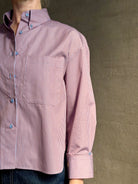 Woman wearing premium cotton poplin JD menswear inspired shirt from TWP  rust and blue stripe with long sleeve 