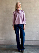 Woman wearing premium cotton poplin JD menswear inspired shirt from TWP  rust and blue stripe with long sleeve and collar