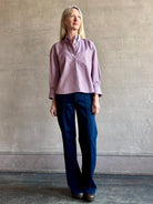 Woman wearing premium cotton poplin JD menswear inspired shirt from TWP in a rust and blue stripe with long sleeve and collar