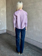 Woman wearing premium cotton poplin JD menswear inspired shirt from TWP in a rust and blue stripe with long sleeve and collar