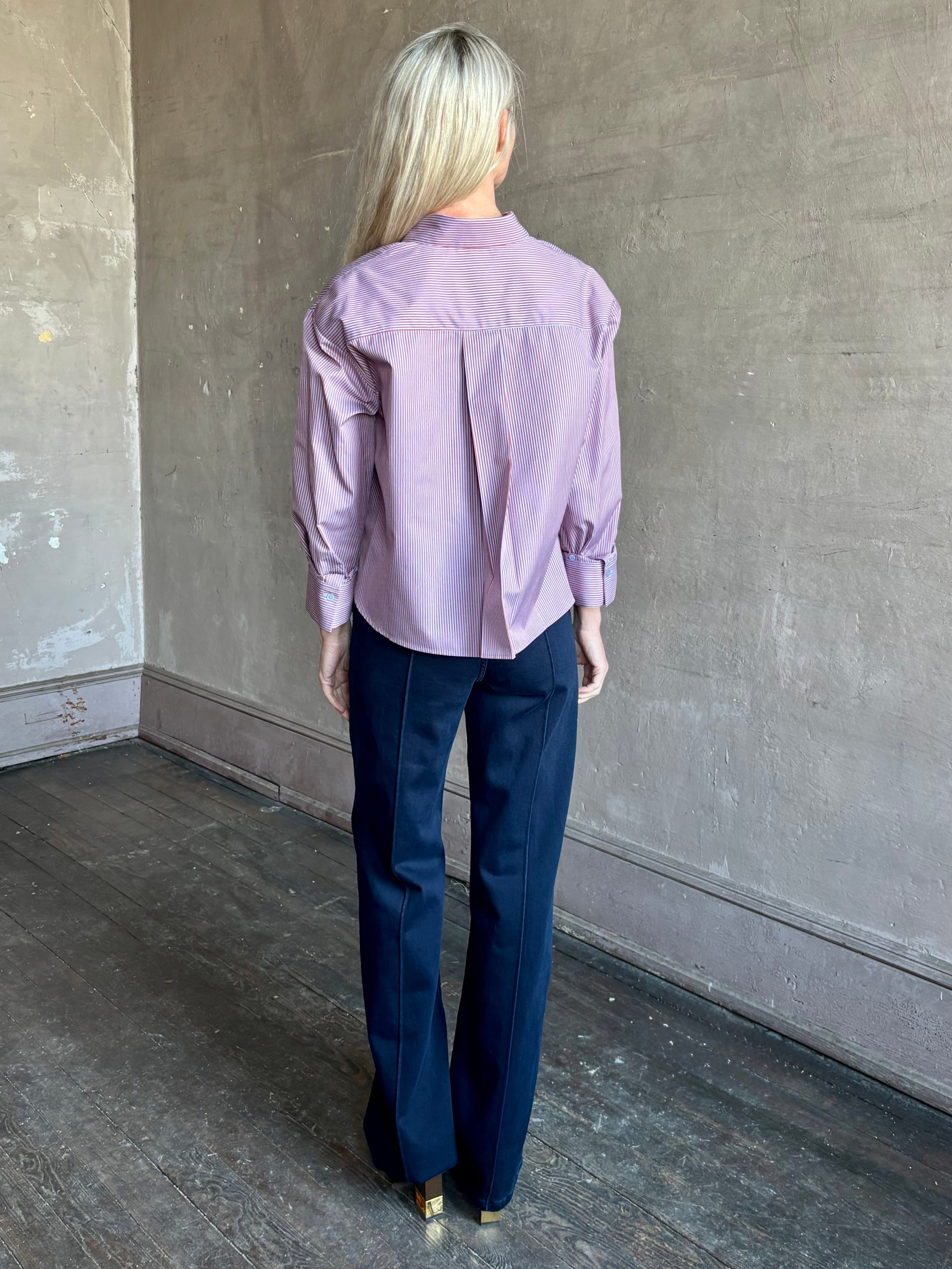 Woman wearing premium cotton poplin JD menswear inspired shirt from TWP in a rust and blue stripe with long sleeve and collar