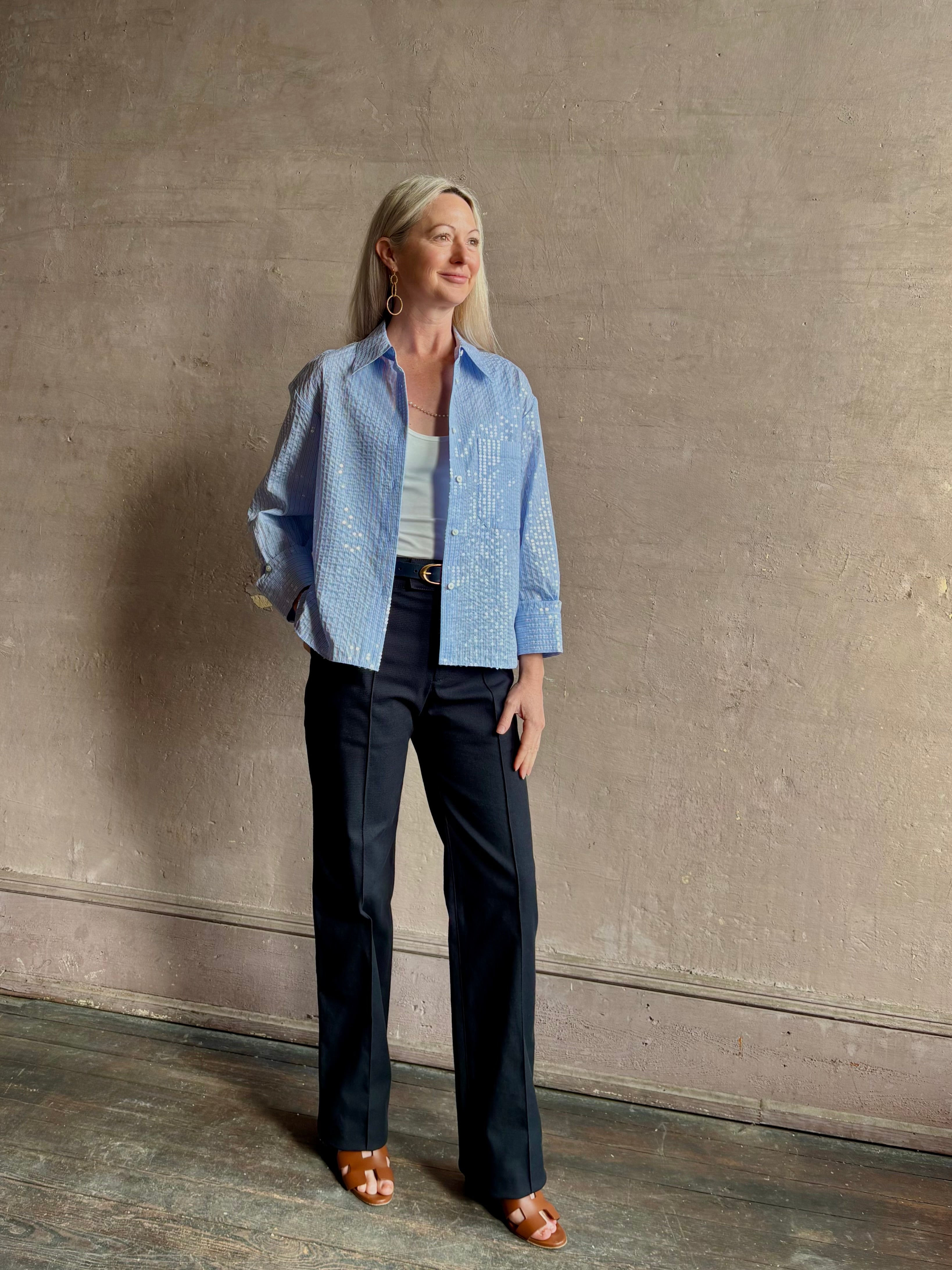 Mature woman wearing JD blue and white stripe collared button-down shirt by TWP with sequin embellishments