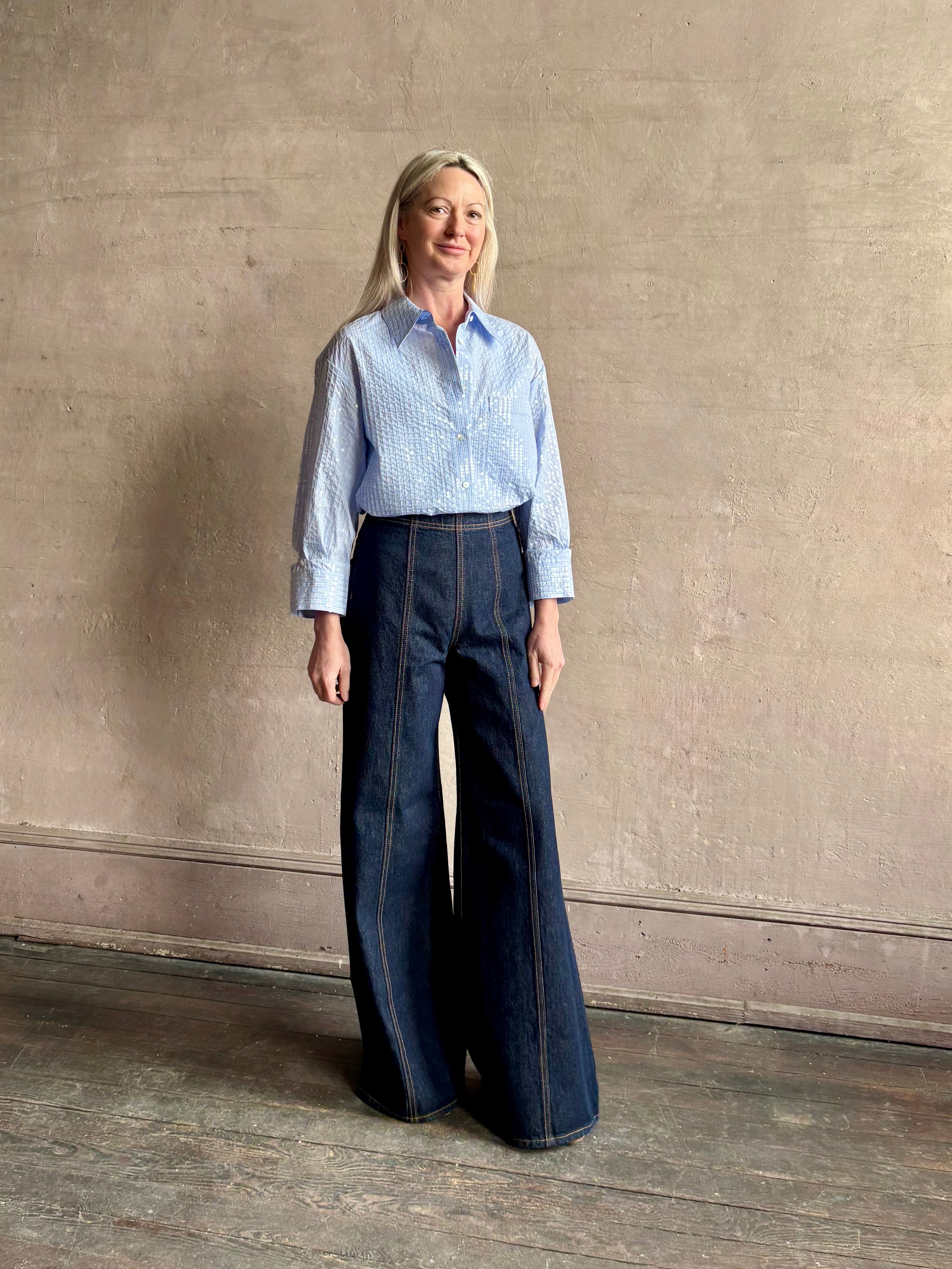 Mature woman wearing JD blue and white stripe collared button-down shirt by TWP with sequin embellishments