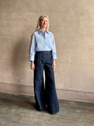 Mature woman wearing JD blue and white stripe collared button-down shirt by TWP with sequin embellishments