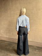 Mature woman wearing JD blue and white stripe collared button-down shirt by TWP with sequin embellishments