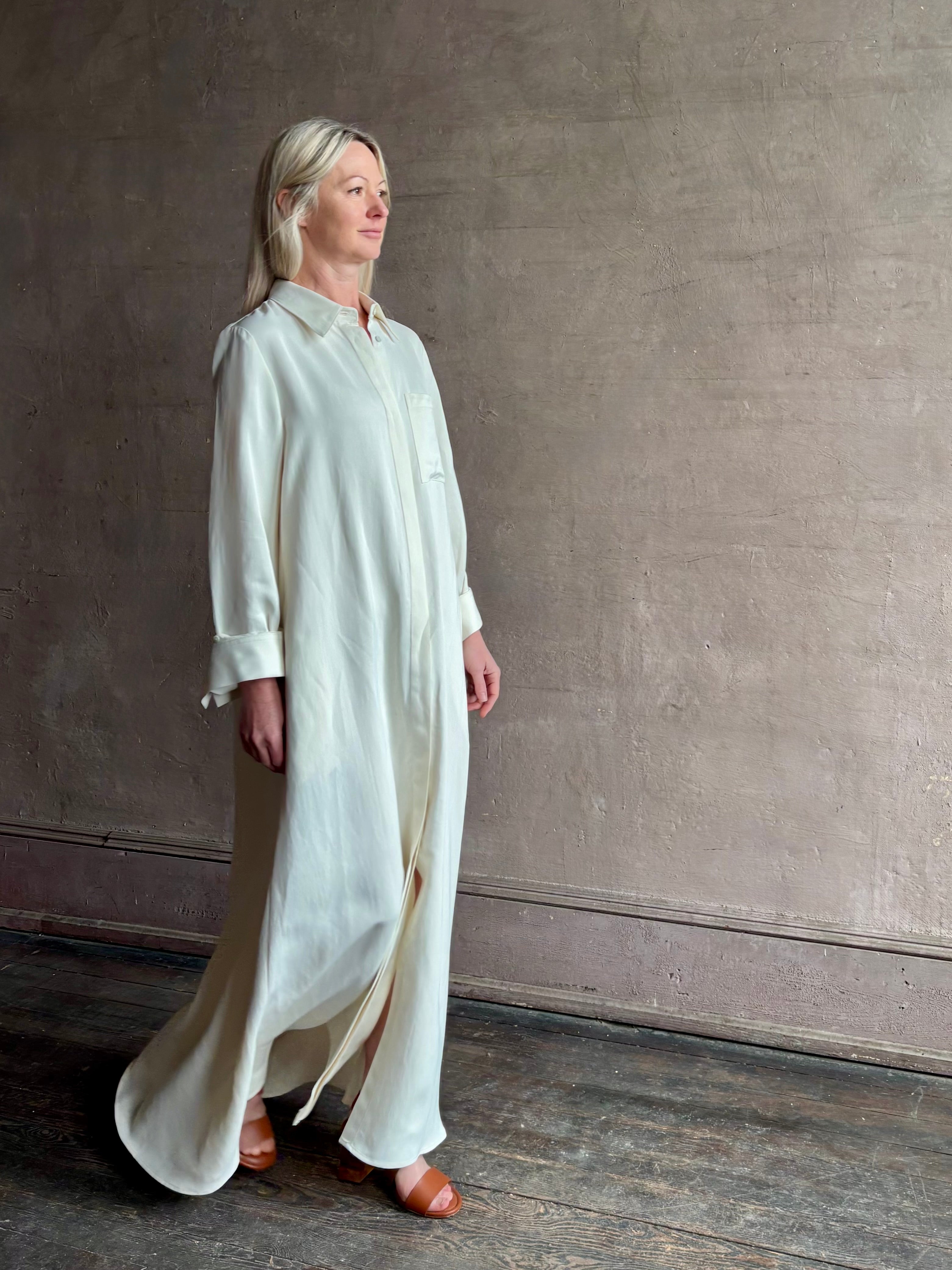 Mature Woman wearing Jenny's Gown from TWP is a women's designer floor length gown rendered in a soft bone hue crafted from a luxurious blend of viscose and linen