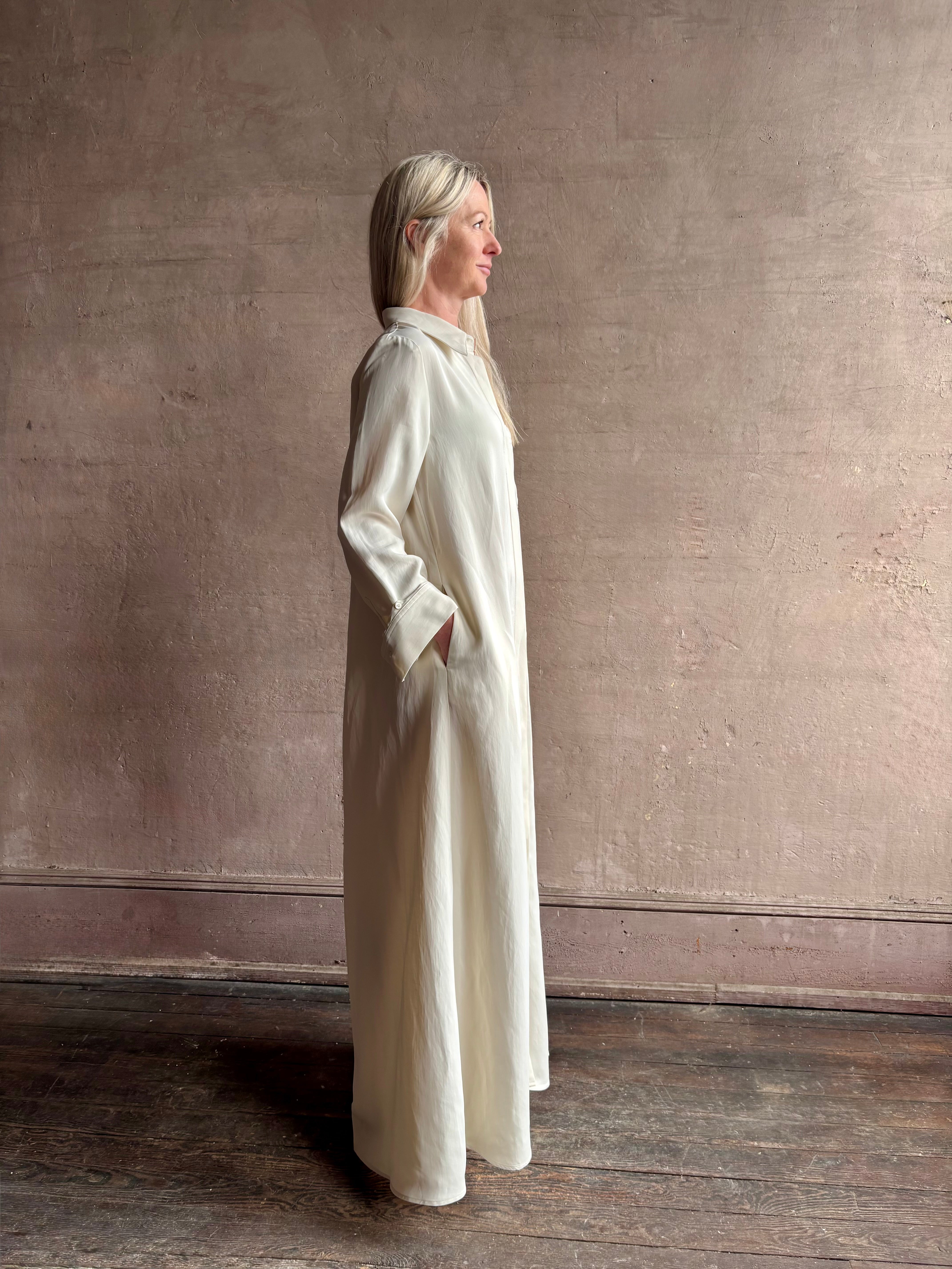 Mature Woman wearing Jenny's Gown from TWP is a women's designer floor length gown with long sleeves and pockets