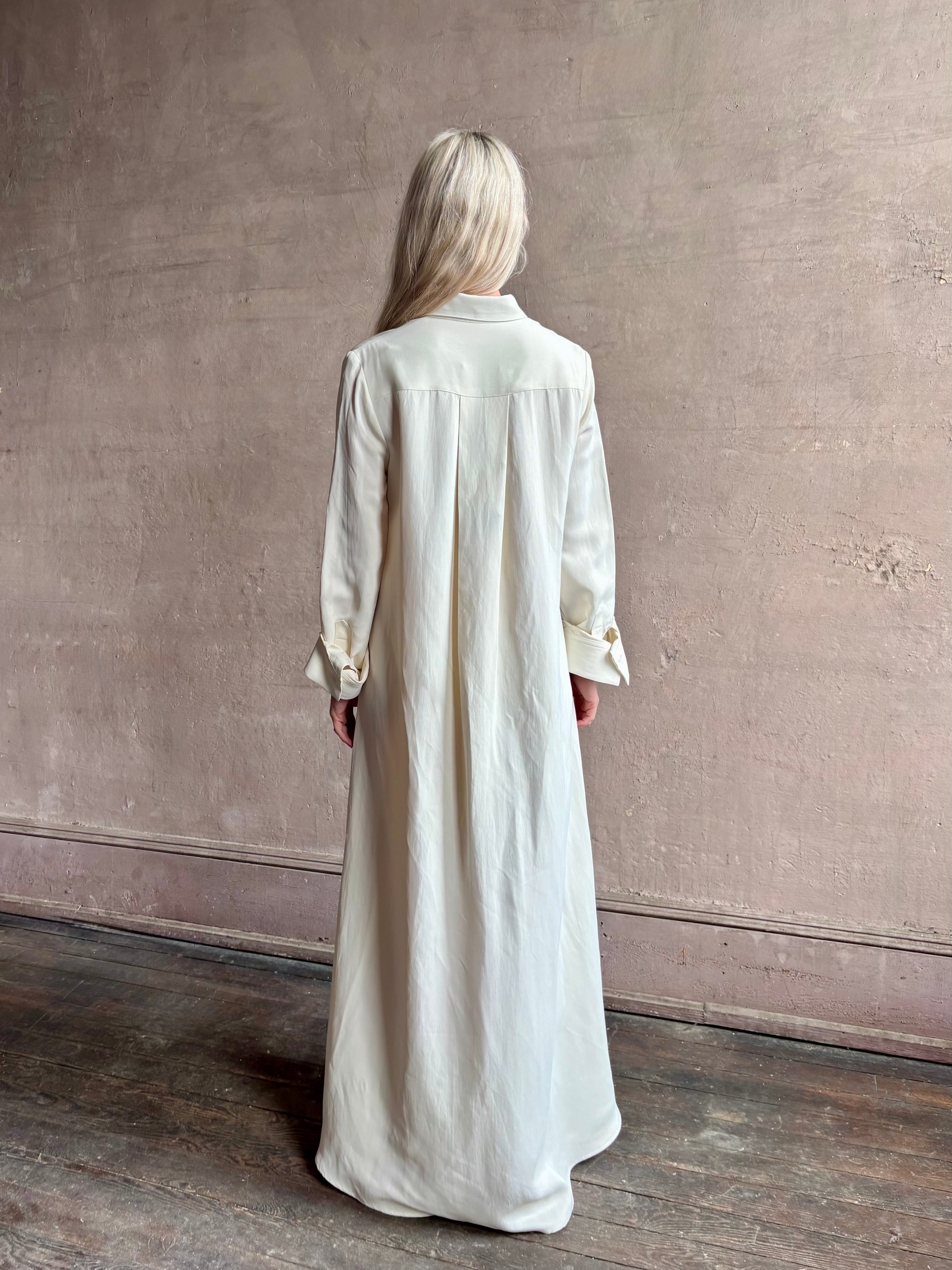Mature Woman wearing Jenny's Gown from TWP is a women's designer floor length gown rendered in a soft bone hue crafted from a luxurious blend of viscose and linen