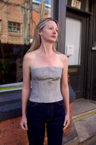 Mature woman wearing luxury brand TWP Jillian cotton-wool bustier in heather grey with bust darts zip closure 