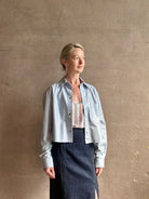 Mature woman reviewing premium lambskin leather TWP Little Big Joe button down cropped Shirt or Jacket in Kentucky Blue with long sleeves