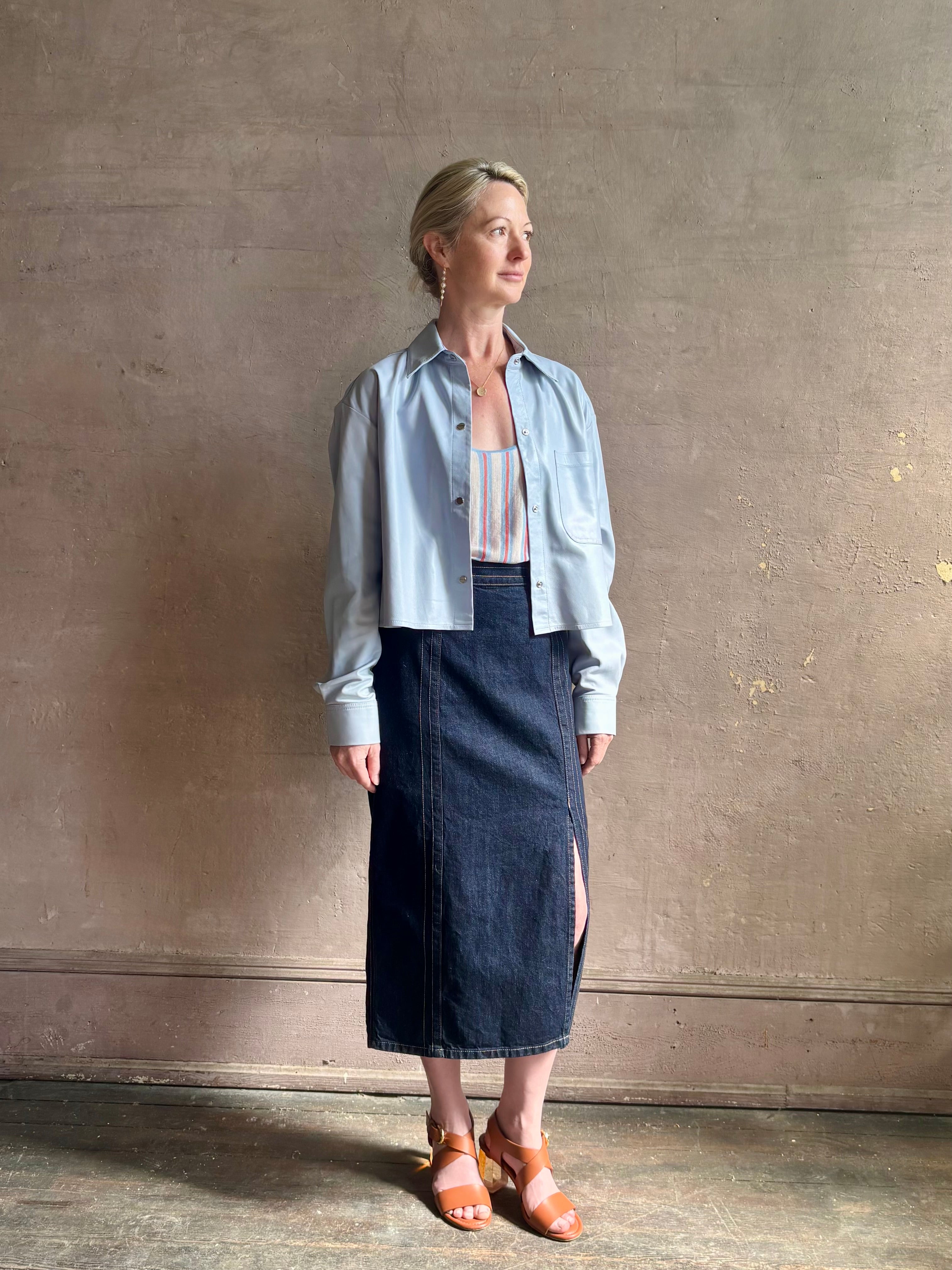 Mature woman reviewing premium lambskin leather TWP Little Big Joe button down cropped Shirt or Jacket in Kentucky Blue with long sleeves