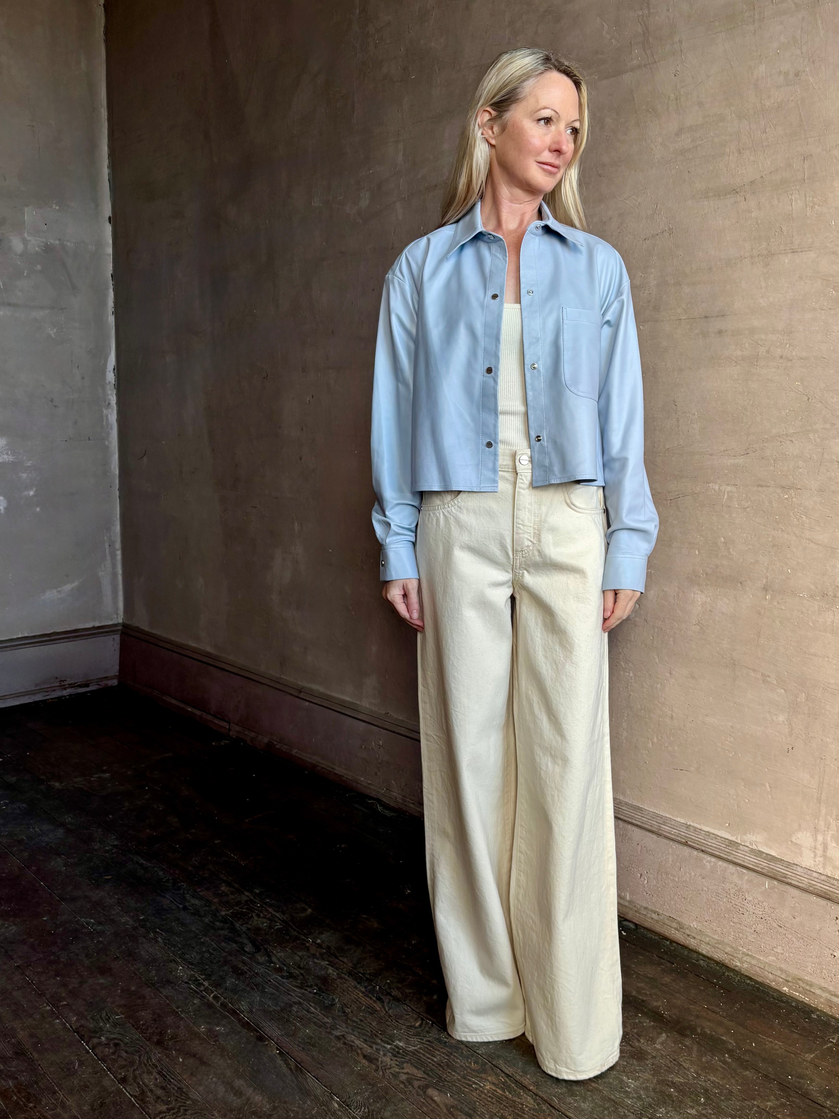 Image of woman wearing premium lambskin leather TWP Little Big Joe button down cropped Shirt in Kentucky Blue 