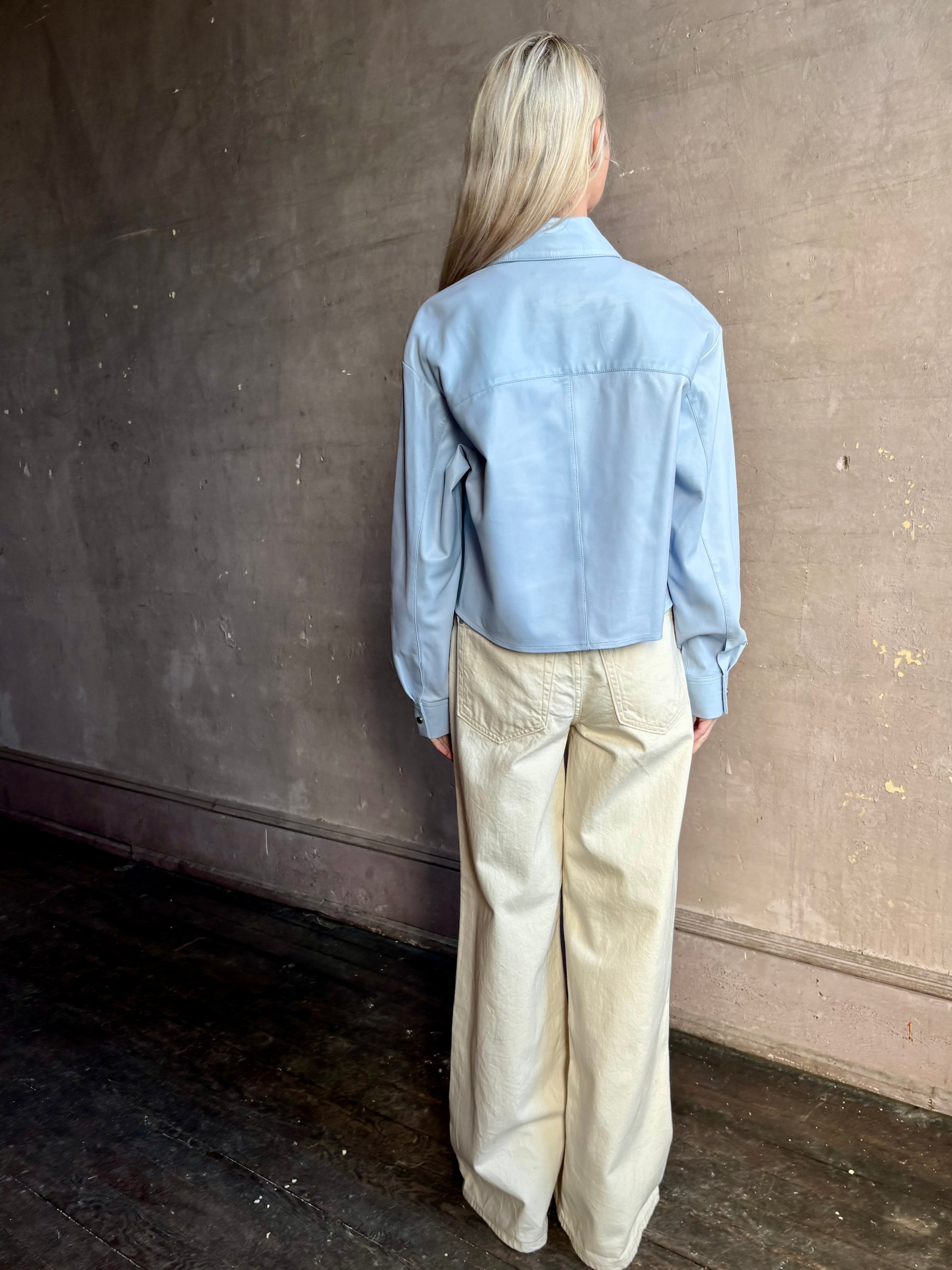 Image of woman wearing premium lambskin leather TWP Little Big Joe button down cropped Shirt in Kentucky Blue 