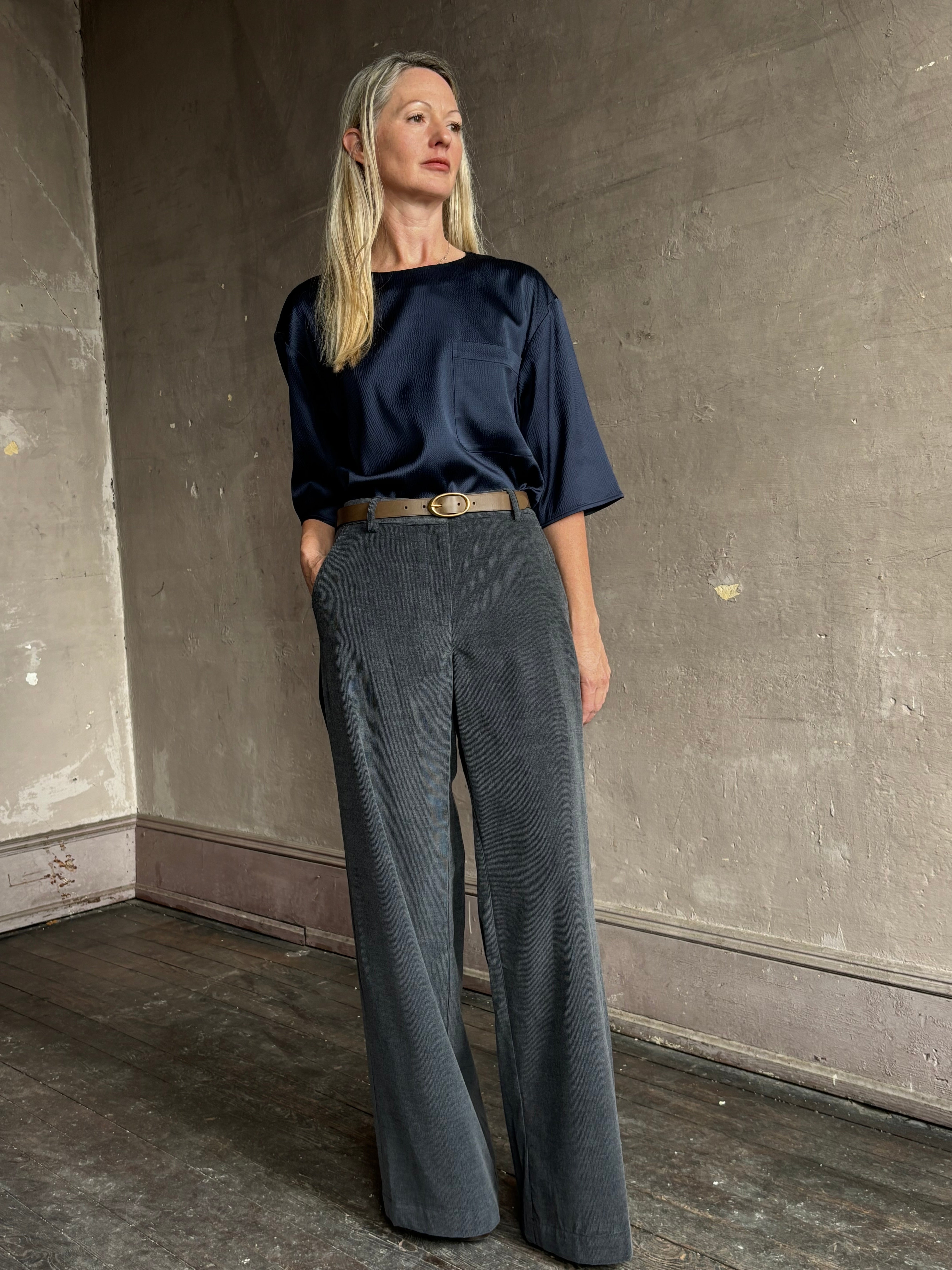 image of mature woman wearing TWP narrow belt in mink  fabricated with premium leather and brass oval buckle