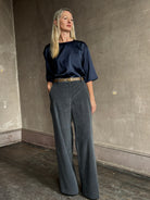 image of mature woman wearing TWP narrow belt in mink  fabricated with premium leather and brass oval buckle