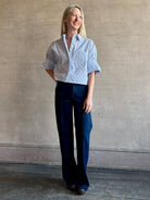 Woman wearing luxury cotton poplin TWP Next EX Shirt White and navy stripe with collar button front made in USA