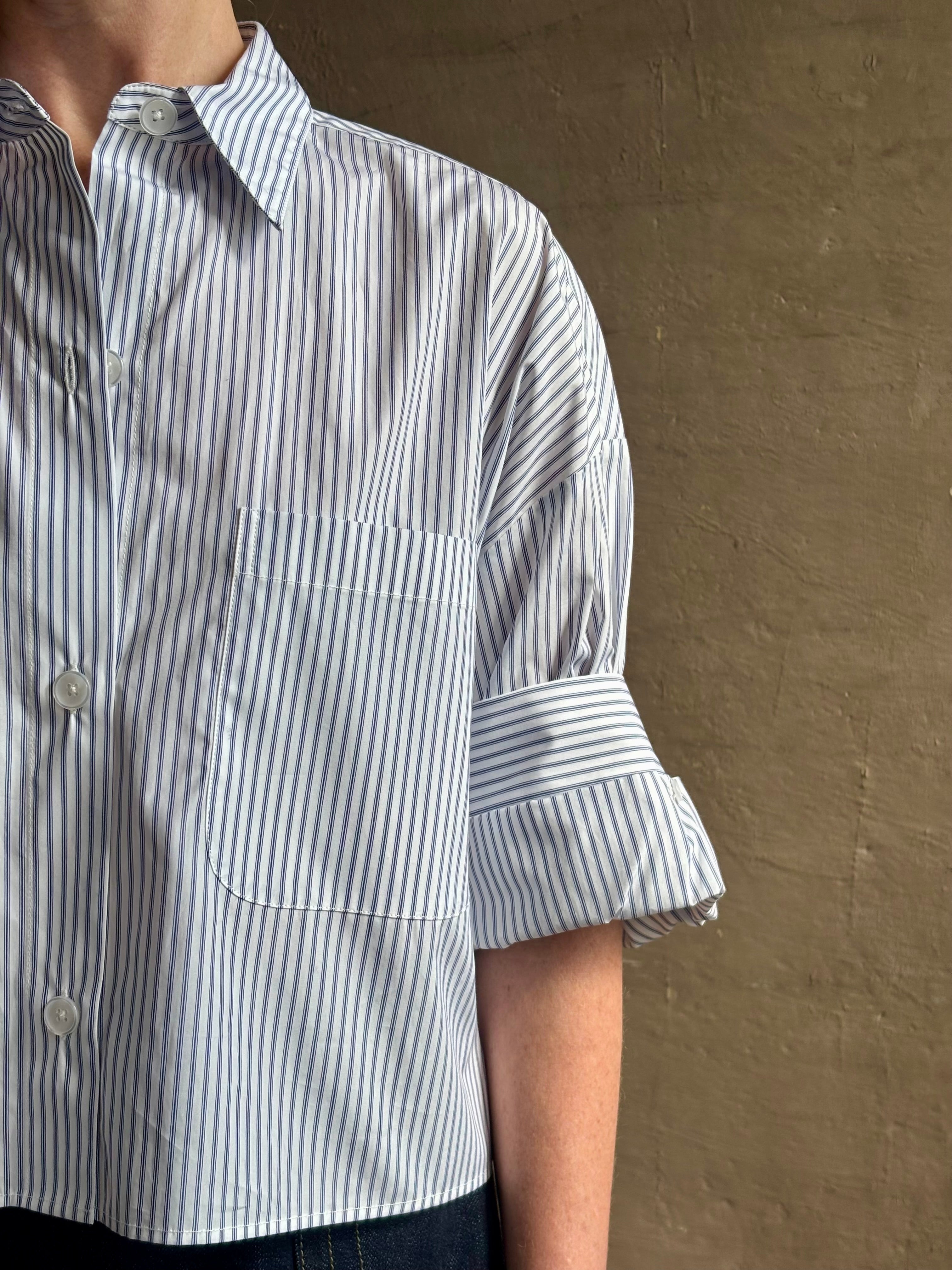 Woman wearing luxury cotton poplin TWP Next EX Shirt White and navy stripe with collar button front made in USA