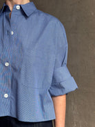 mature model wearing classic cotton poplin button down next ex top by luxury brand TWP in a blue and white 