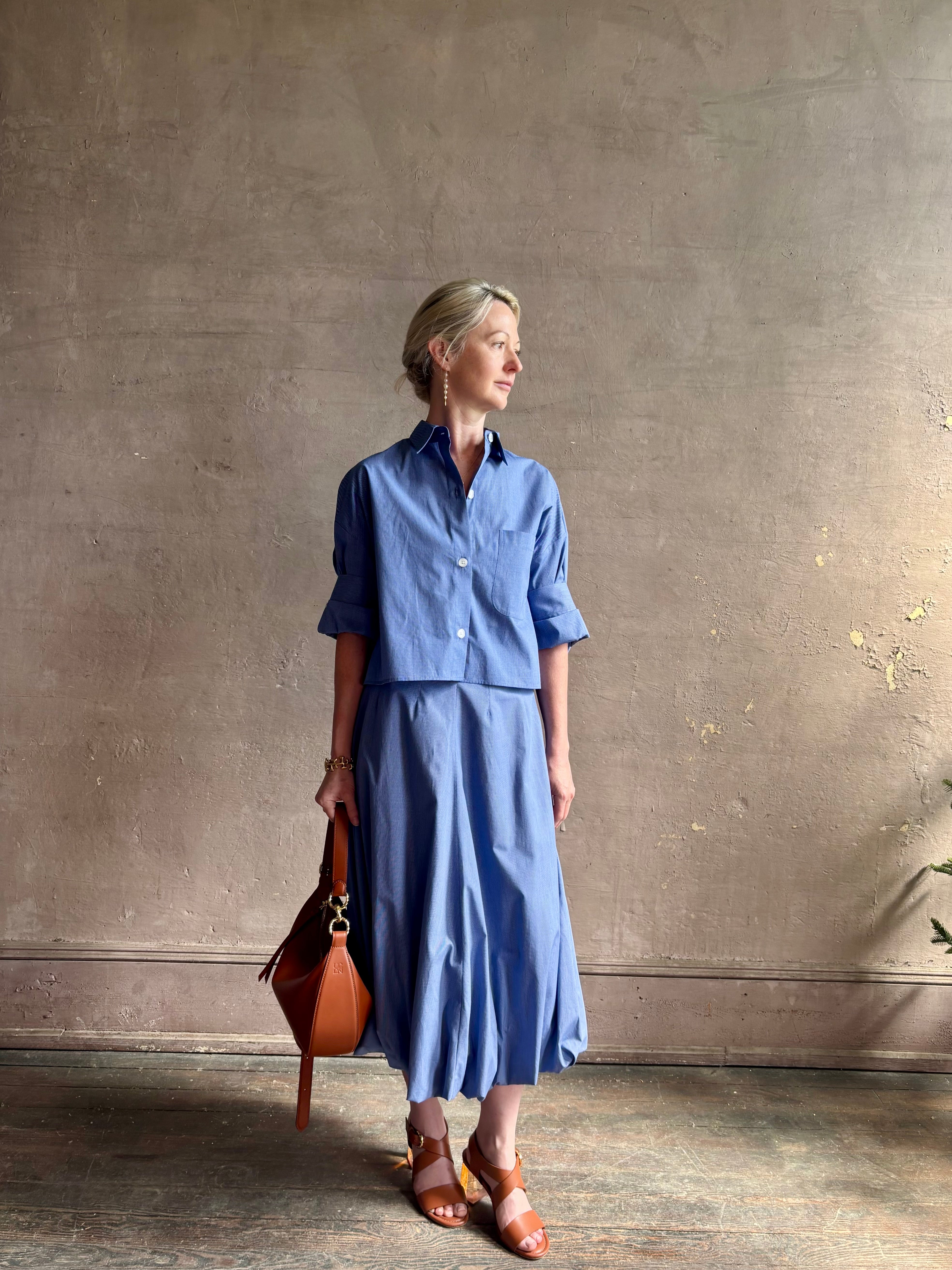 mature model wearing classic cotton poplin button down next ex top by luxury brand TWP in a blue and white 