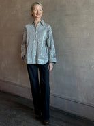 Mature woman wearing TWP premium cotton-blend button down indigo striped shirt with sequins, long sleeve and collar