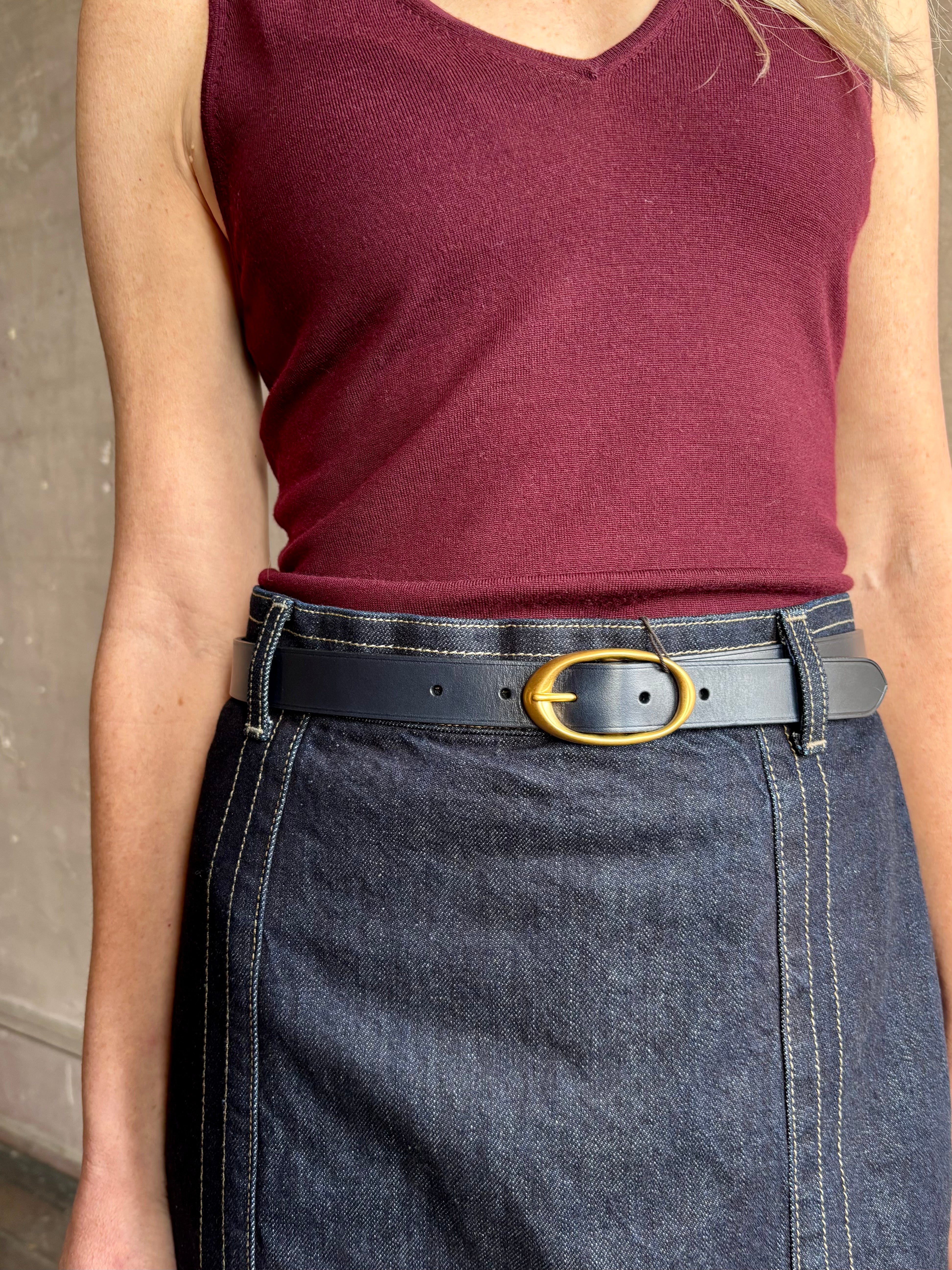 Image of woman wearing TWP premium Italian leather Narrow Belt in navy blue with matte brass hardware