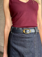 Image of woman wearing TWP premium Italian leather Narrow Belt in navy blue with matte brass hardware