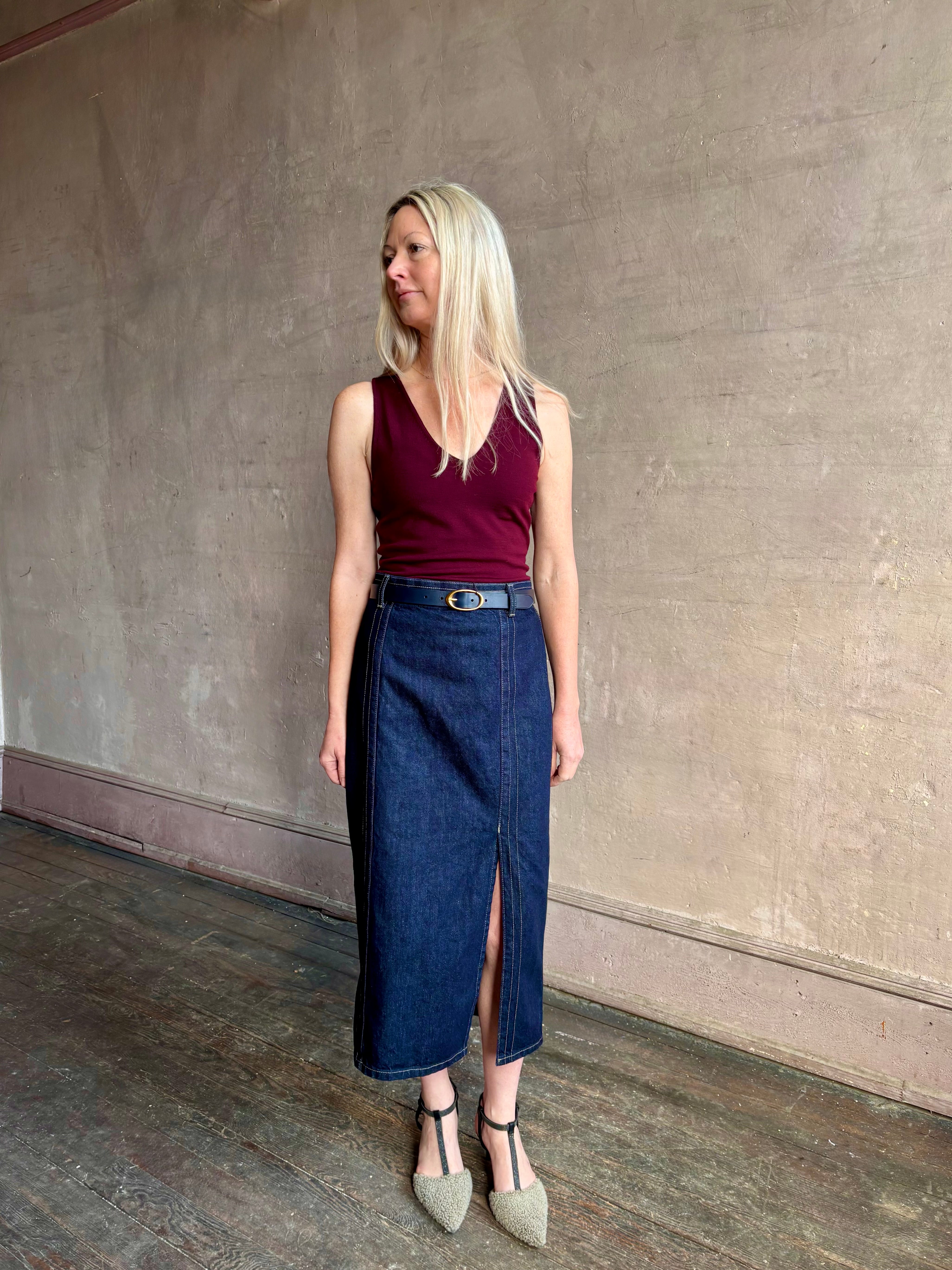 Image of woman wearing TWP premium Italian leather Narrow Belt in navy blue with matte brass hardware