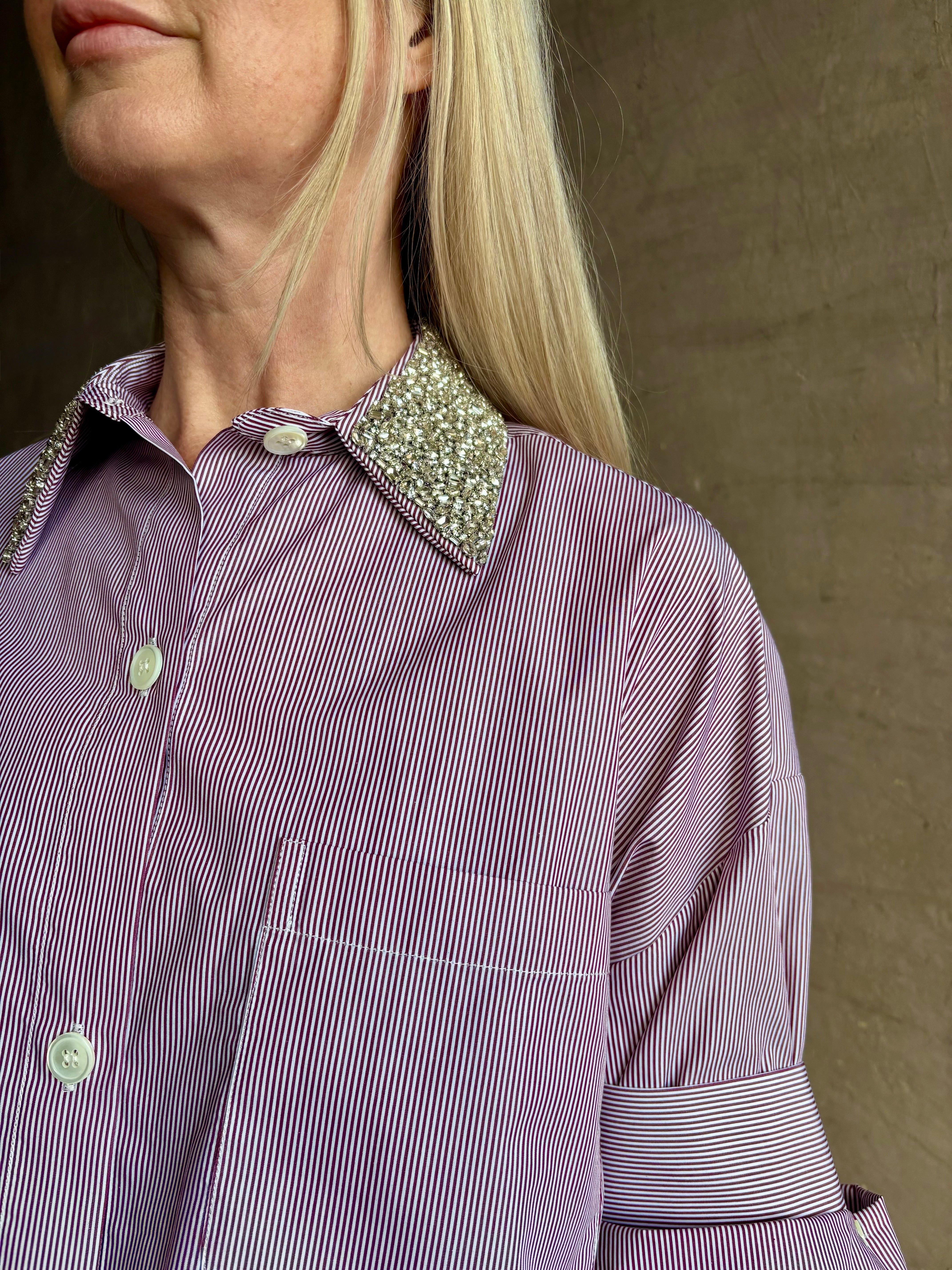 Image of mature woman wearing sophisticated TWP Next EX cotton shirt with elevated Crystal embellished Collar in White and wine stripe made in USA