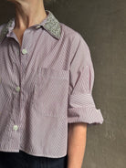 Image of mature woman wearing sophisticated TWP Next EX cotton shirt with elevated Crystal embellished Collar in White and wine stripe made in USA