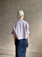 Image of mature woman wearing sophisticated TWP Next EX cotton shirt with elevated Crystal embellished Collar in White and wine stripe made in USA