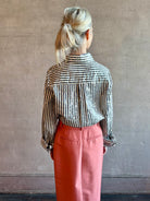 Image of woman wearing TWP premium cotton-blend button down indigo striped button down shirt with sequins, long sleeve and collar.