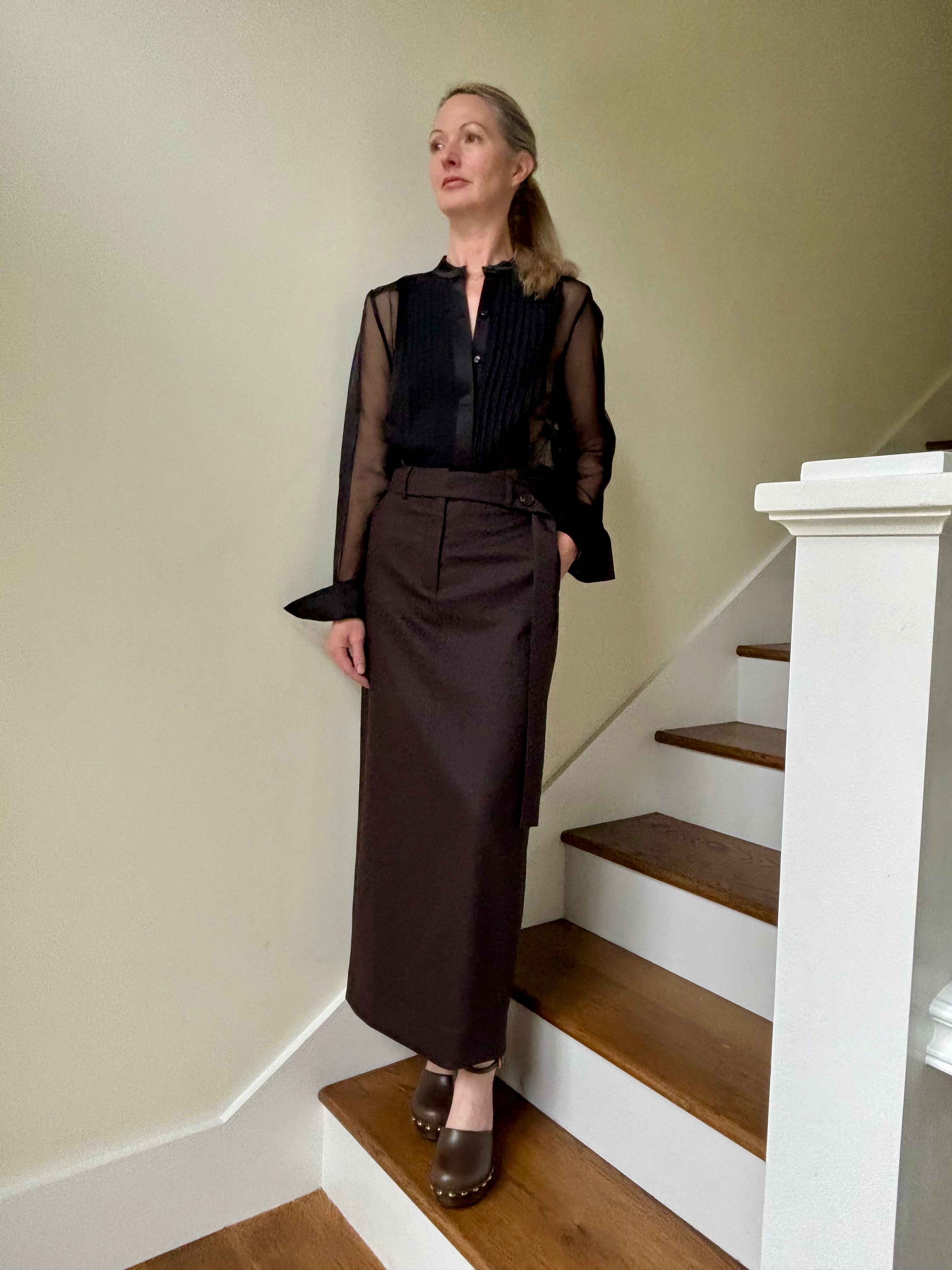 Image of mature woman wearing luxury brand TWP Peyton blouse with a pleated tuxedo front, long sleeve and sophisticated sheer silk fabric
