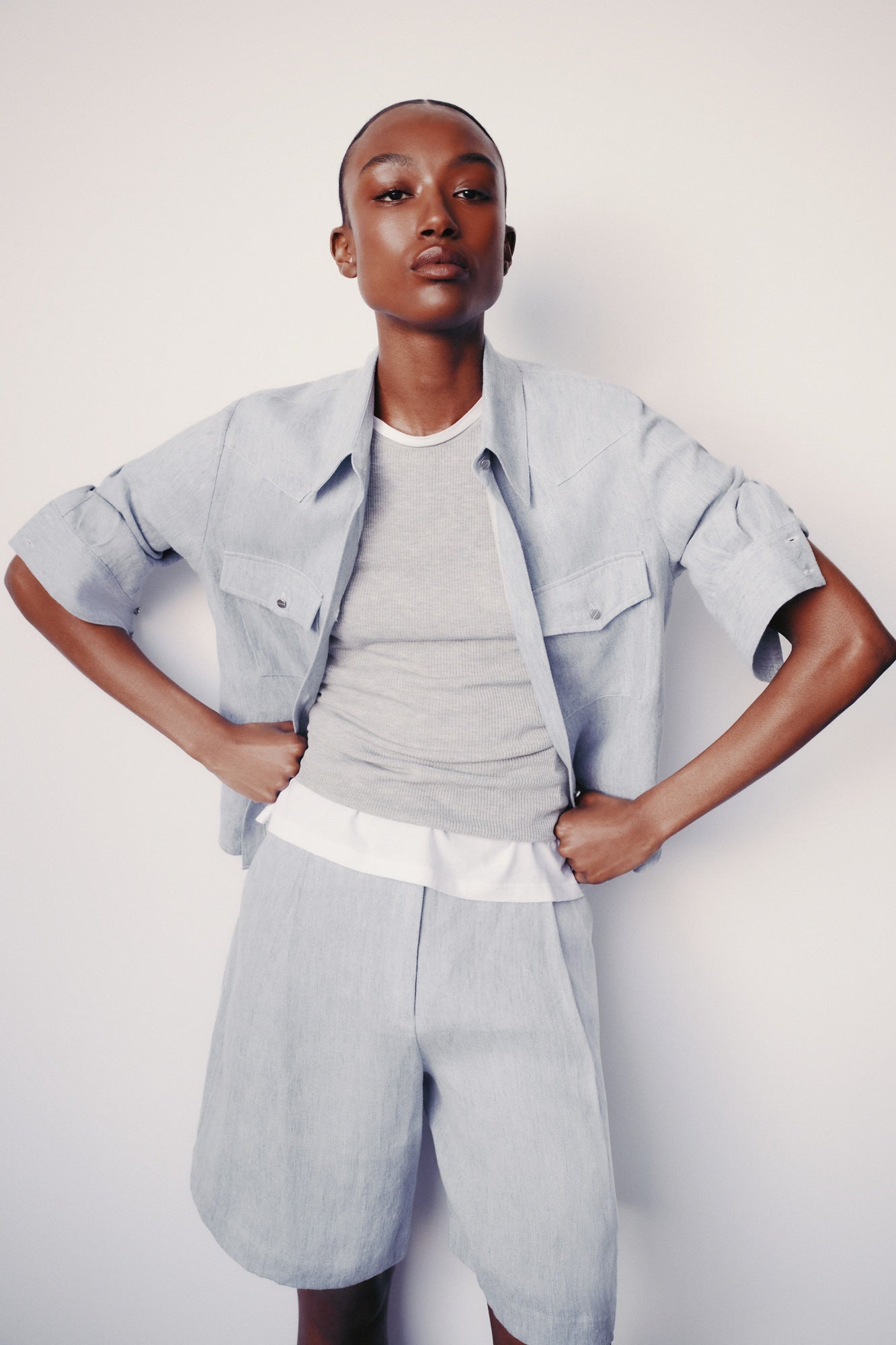 Image of model wearing luxury TWP New Carter indigo Button Up hemp top combining timeless workwear with contemporary refinement 