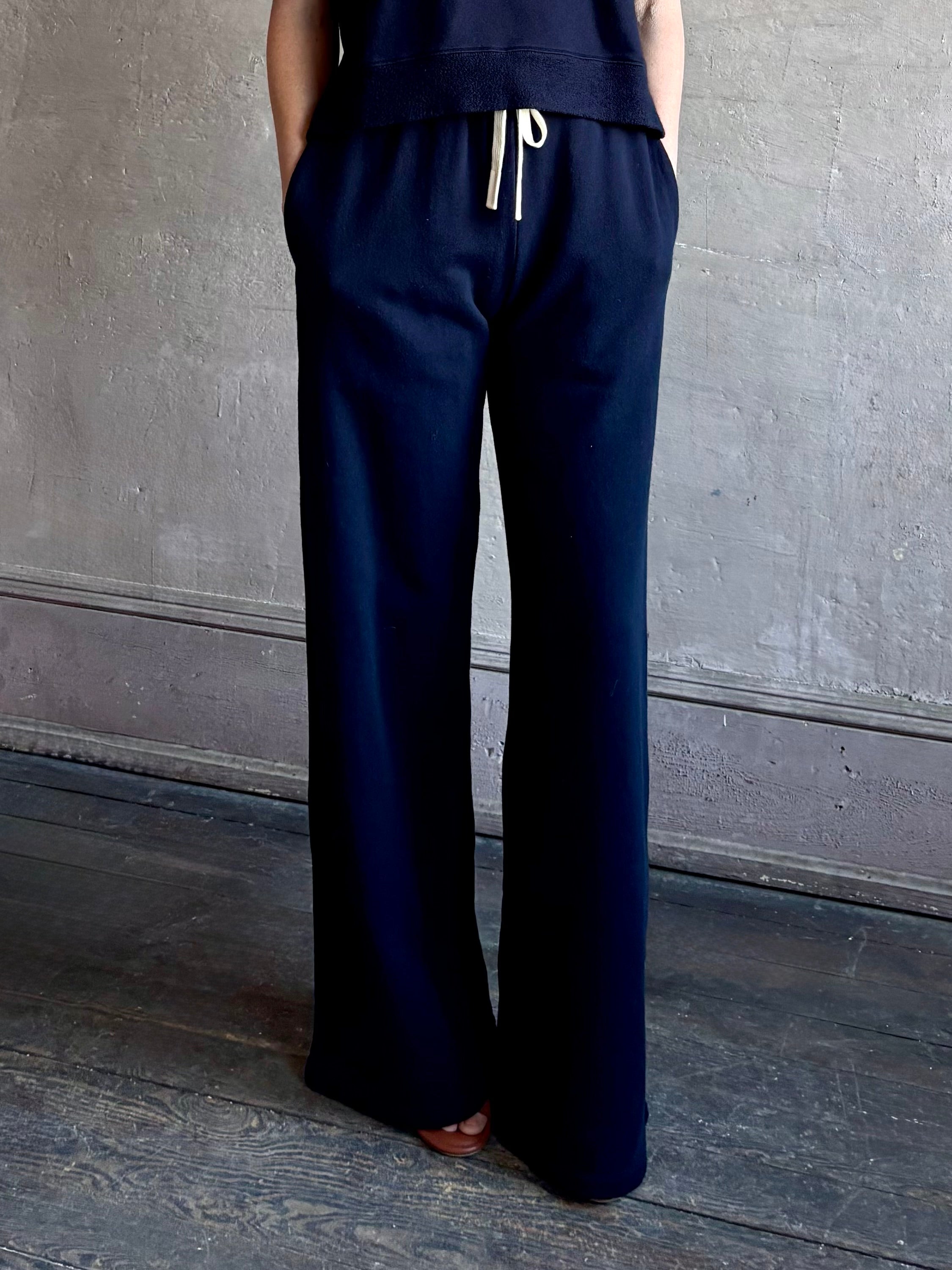 Mature woman wearing the PJ Pant from TWP is a luxuriously relaxed women's designer lounge pant crafted from cotton with a straight leg and effortless pull-on waist 