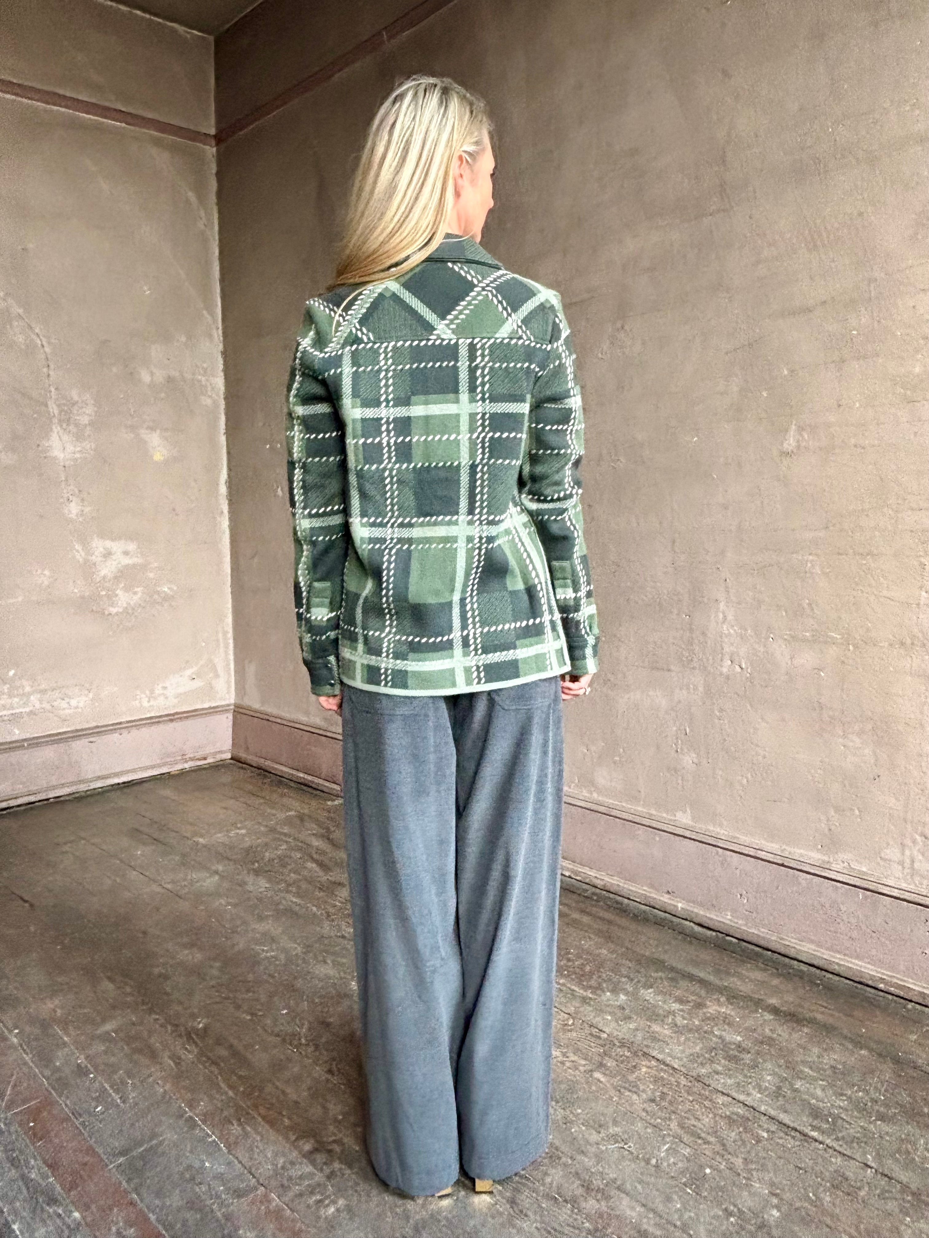 Image of mature woman wearing TWP ranchers cardigan fabricated with premium cashmere in classic green plaid