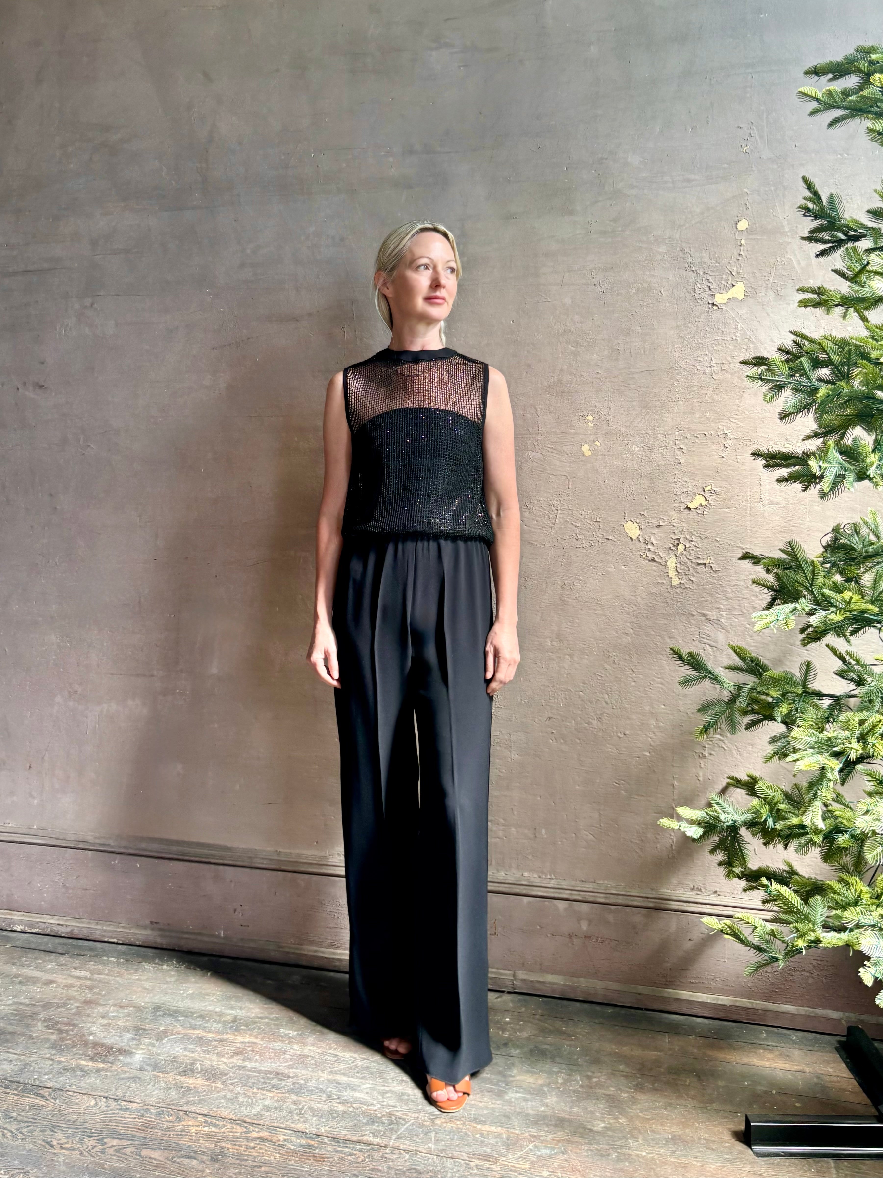 Image of mature woman wearing Women's designer clothing label TWP short muscle tank in black with subtle sequin embellishments perfect for luxury layering 