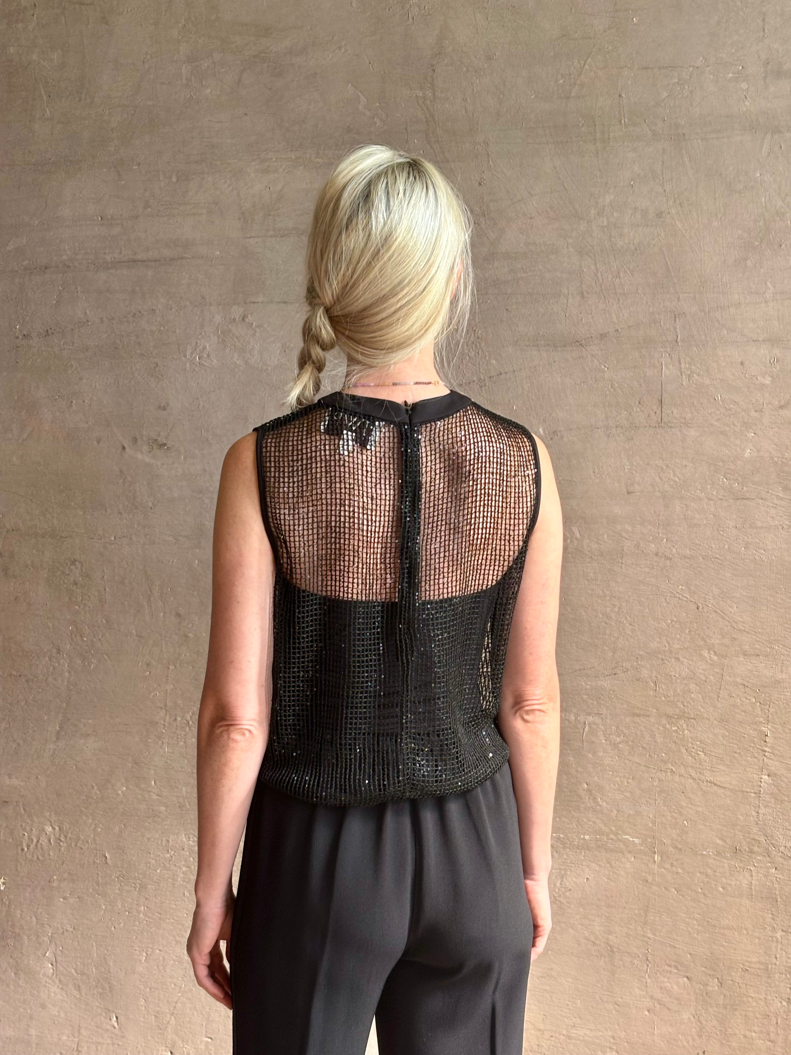 Image of mature woman wearing Women's designer clothing label TWP short muscle tank in black with subtle sequin embellishments perfect for luxury layering 