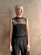 Image of mature woman wearing Women's designer clothing label TWP short muscle tank in black with subtle sequin embellishments perfect for luxury layering 