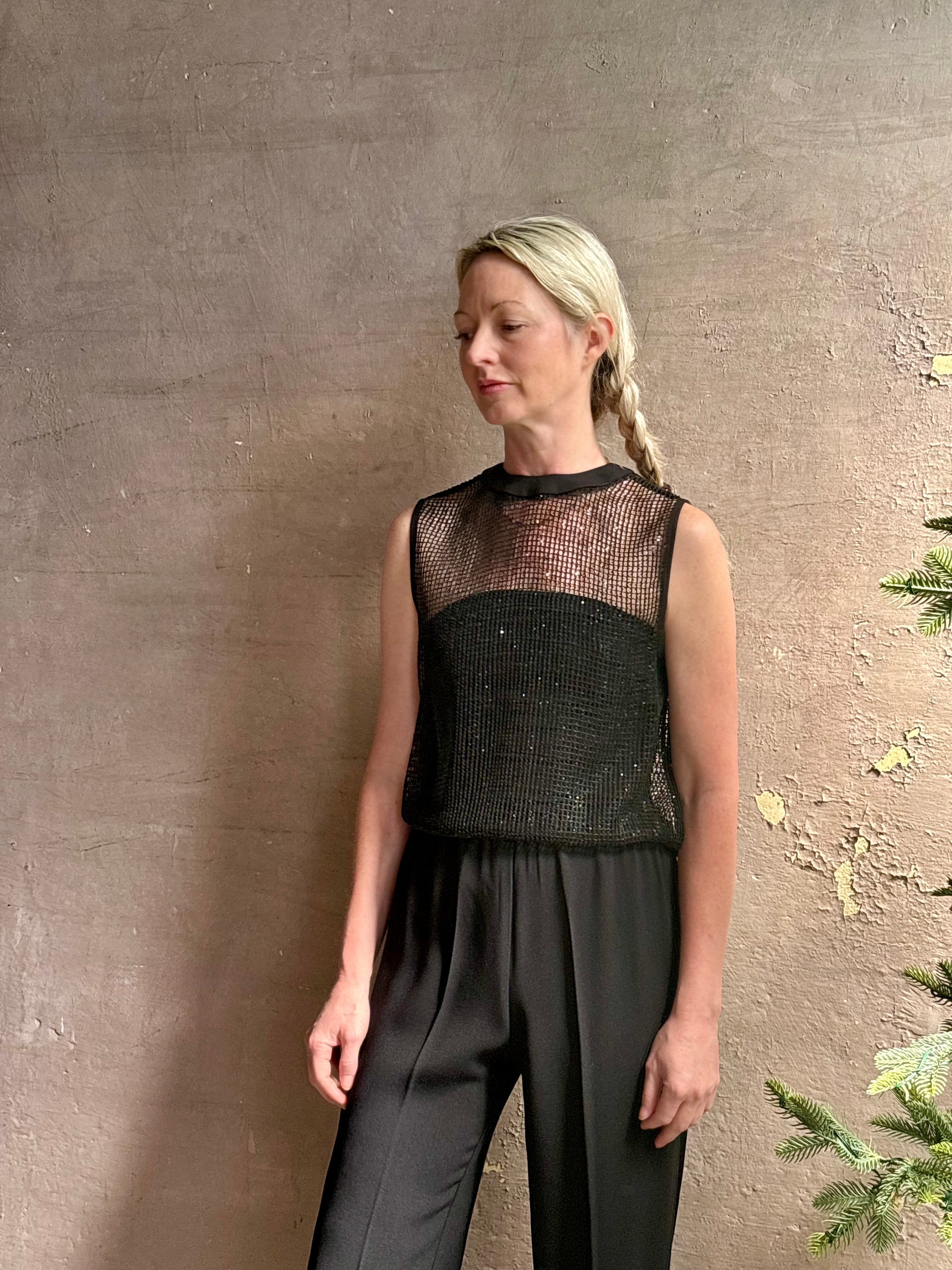Image of mature woman wearing Women's designer clothing label TWP short muscle tank in black with subtle sequin embellishments perfect for luxury layering 