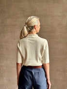 mature woman wearing quality TWP ivory short sleeve knit polo top ribbed texture collar henley 