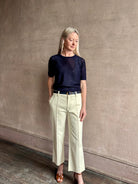 Mature woman wearing luxury Short Sleeve navy blue cashmere Tee Sweater from TWP with open weave and crew neck