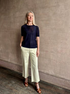 Mature woman wearing luxury Short Sleeve navy blue cashmere Tee Sweater from TWP with open weave and crew neck