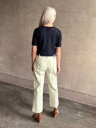 Mature woman wearing luxury Short Sleeve navy blue cashmere Tee Sweater from TWP with open weave and crew neck