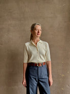 mature woman wearing quality TWP ivory short sleeve knit polo top ribbed texture collar henley 