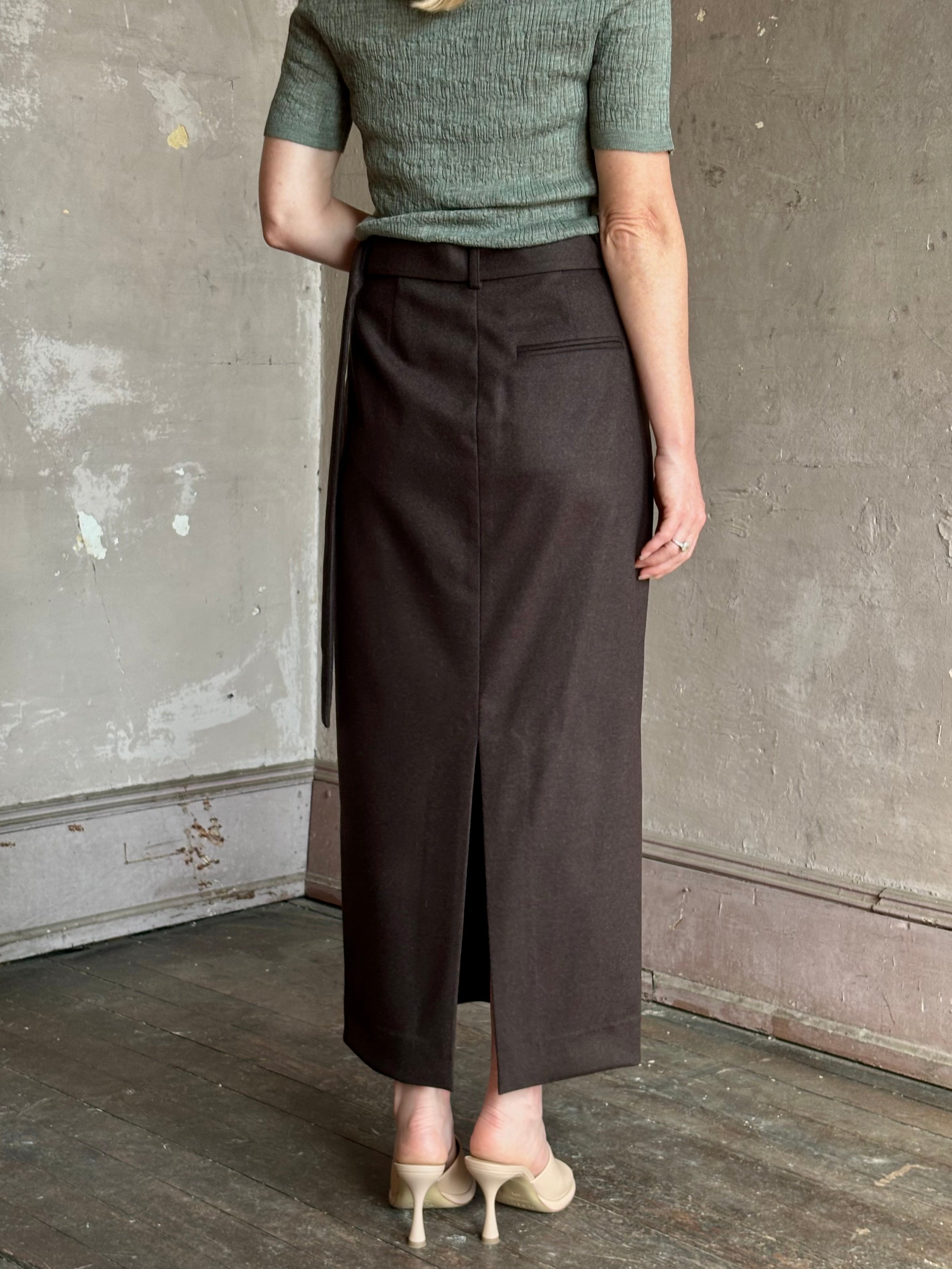 Mature woman wearing elegant TWP slit pencil skirt wool chocolate brown elevated tailored maxi skirt