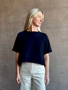 Mature woman waring the Slouchy Rolled Tee Top from TWP luxury women's designer tee rendered in a versatile navy blue and crafted from 100% cotton with short sleeves and crew neckline